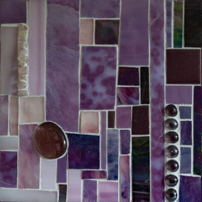 Purple glass, stones, and grout on wood