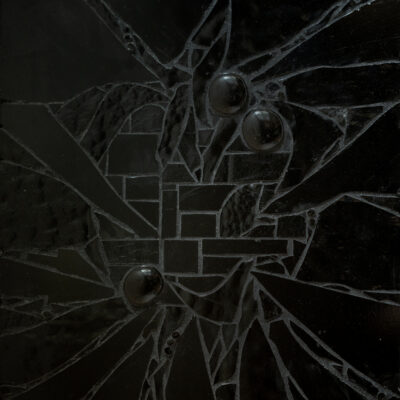 Black glass and grout on wood