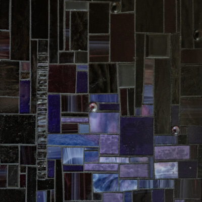 Purple and black glass and grout on wood