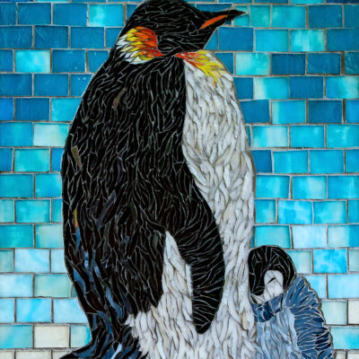 Penguins made out of glass and grout on wood