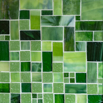 Green glass tiles and grout on wood.
